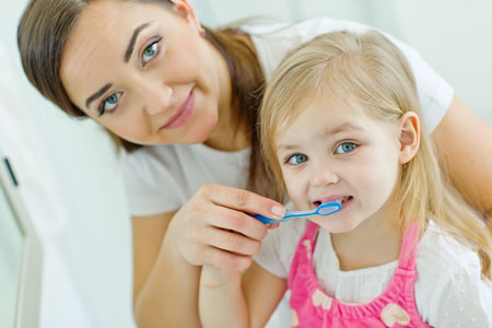 Mom and Daughter brushing their teeth - Pediatric Dentist in Paducah, KY