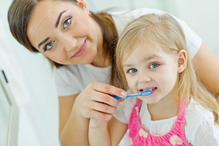 Mom and Daughter brushing their teeth - Pediatric Dentist in Paducah, KY